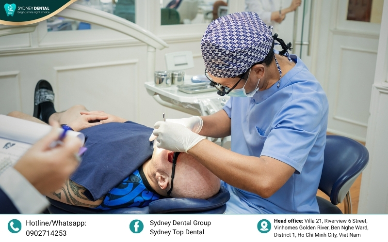 A dentist consulting with a patient, examining a 3D dental scan to determine if they qualify for immediate implant placement.
